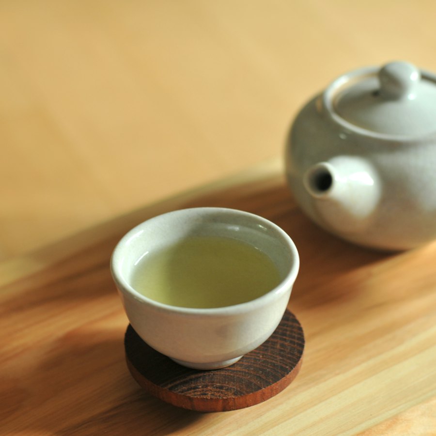 木のテーブルに置かれた白い器のお茶